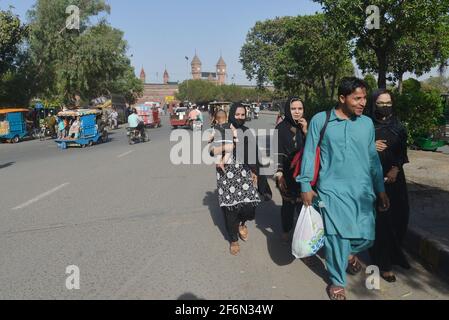 Lahore, Pakistan. 01st Apr, 2021. Pakistani family members are travelling on foot as facing trouble due to closures of speedo Buses, orange line metro train (OLMT) because of new restrictions to contain the spread of the Covid-19 in provincial capital city in Lahore. (Photo by Rana Sajid Hussain/Pacific Press) Credit: Pacific Press Media Production Corp./Alamy Live News Stock Photo