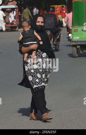 Lahore, Pakistan. 01st Apr, 2021. Pakistani family members are travelling on foot as facing trouble due to closures of speedo Buses, orange line metro train (OLMT) because of new restrictions to contain the spread of the Covid-19 in provincial capital city in Lahore. (Photo by Rana Sajid Hussain/Pacific Press) Credit: Pacific Press Media Production Corp./Alamy Live News Stock Photo