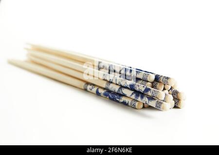 Wooden chopsticks with stacked stack pattern isolated on white background. Stock Photo