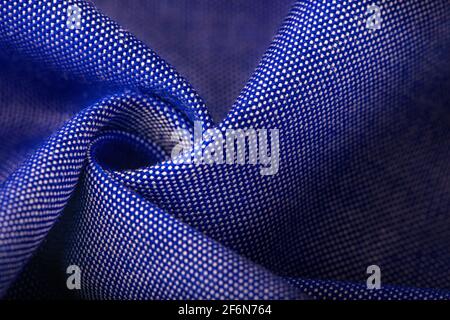 Texture, background, template. Silk other Cotton fabric white and blue, silk other Cotton drapery. In closeup, threads of fabric and a pattern of text Stock Photo