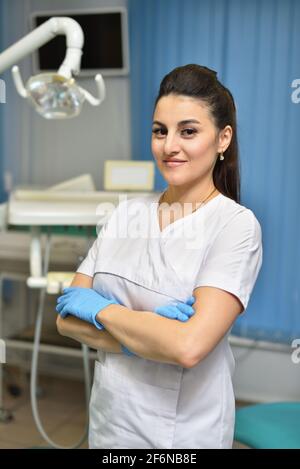 Portrait of a young woman dentist stands in his workplace Stock Photo