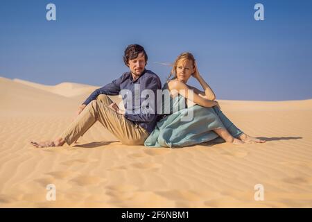 Relationship problems between a couple - a man and a woman. Family conflict. Man and woman have a heated relationship, sit in the hot desert with Stock Photo