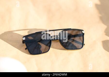 Oversized sunglasses model with big black lenses shoot outdoors in a sunny day closeup . Selective focus Stock Photo