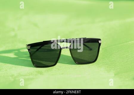 Oversized sunglasses model with big black lenses shoot outdoors in a sunny day closeup . Selective focus Stock Photo