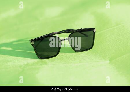 Oversized sunglasses model with big black lenses shoot outdoors in a sunny day closeup . Selective focus Stock Photo