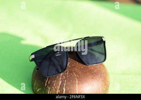 Oversized sunglasses model with big black lenses shoot outdoors in a sunny day closeup . Selective focus Stock Photo