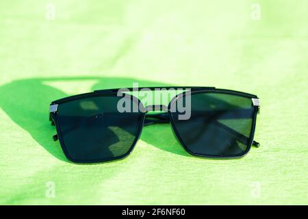 Oversized sunglasses model with big black lenses shoot outdoors in a sunny day closeup . Selective focus Stock Photo