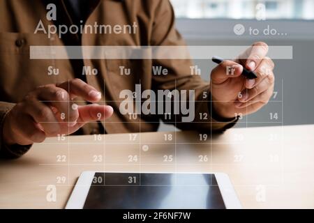 man work business writing working and schedule Calendar busy schedule tasks and appointments in Weekly Planner Schedule Stock Photo