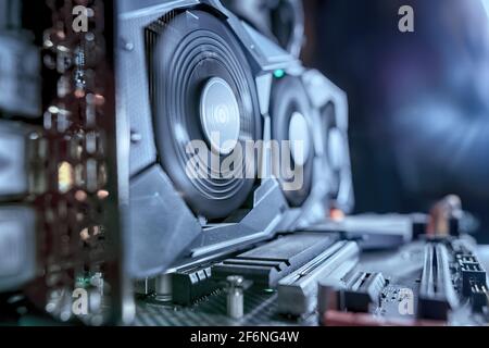 Close up of working working graphic card on board. Toned image with selective focus Stock Photo