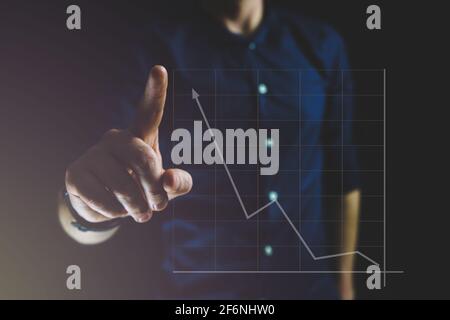 Businessman points on hologram chart with hand. Stock market and business growth Stock Photo