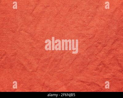 Wrinkled linen texture. Textured surface of red flax fabric Stock Photo