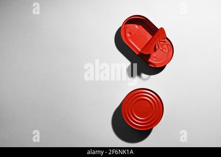 Red painted open tin can on gray background Stock Photo