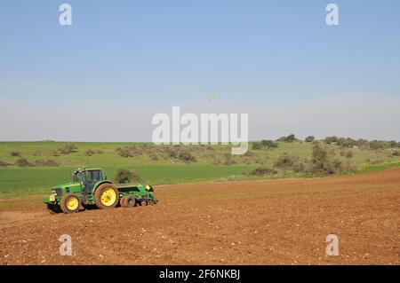 A planter is a farm implement, usually towed behind a tractor, that sows (plants) seeds in rows throughout a field Stock Photo