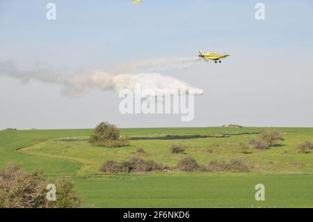 Air Tractor AT-802F fire fighting plane (4x-AFY) operated by him-Nir Aviation is dropping flame retardant (here water was used to avoid damage and cos Stock Photo