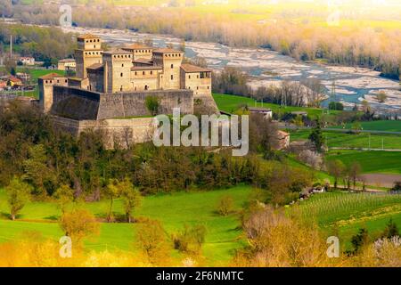 aerial view of the medieval fairy castle with a colorful river and yellow lights at the edges beautiful background as in fairy tales Stock Photo