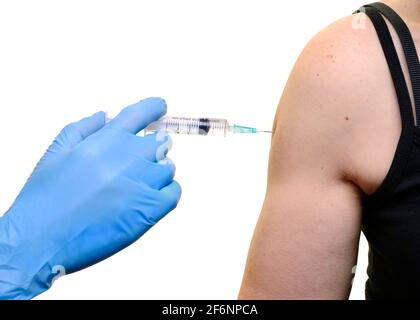 Young Woman Receiving an Injection in Her Arm, Vaccination, Jab, Coronavirus Vaccine Stock Photo