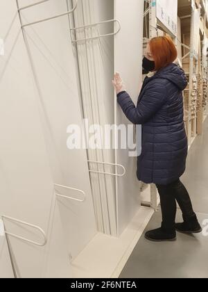 woman in medical furniture laminated chipboard sheets in a construction store Stock Photo