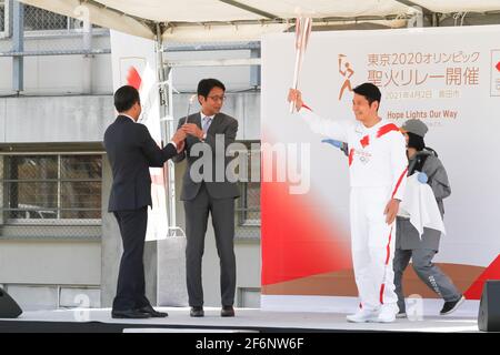 Iida, Japan, 02/04/2021, Olympic torch event in iida city. Runner and holder of the torch showing the lighted torch to the people. Stock Photo