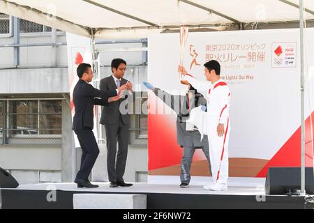 Iida, Japan, 02/04/2021, Olympic torch event in iida city. Runner and holder of the torch showing the lighted torch to the people. Stock Photo