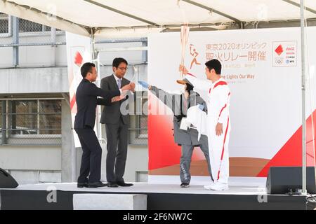 Iida, Japan, 02/04/2021, Olympic torch event in iida city. Runner and holder of the torch showing the lighted torch to the people. Stock Photo