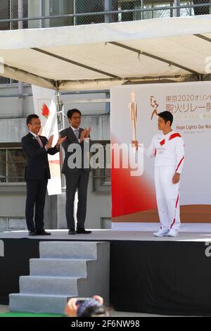 Iida, Japan, 02/04/2021, Olympic torch event in iida city. Runner and holder of the torch showing the lighted torch to the people. Stock Photo