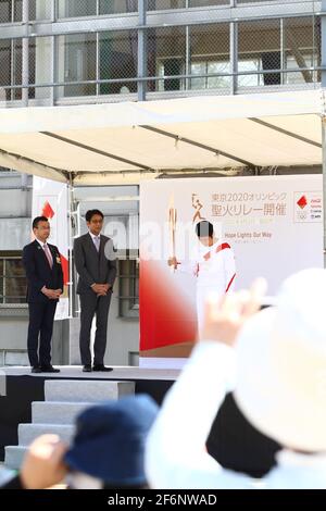 Iida, Japan, 02/04/2021, Olympic torch event in iida city. Runner and holder of the torch showing the lighted torch to the people. Stock Photo