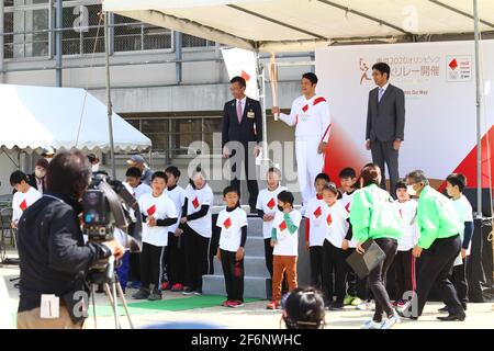 Iida, Japan, 02/04/2021, Olympic torch event in iida city. Runner and holder of the torch showing the lighted torch to the people. Stock Photo