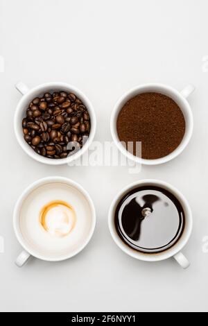 top view of prepared americano near fresh ground coffee and beans in cups on white Stock Photo