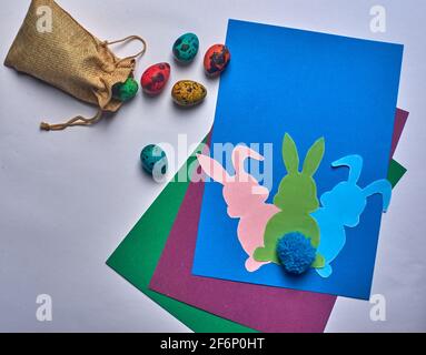 Easter bunnies with tail and eggs on a blue background Stock Photo