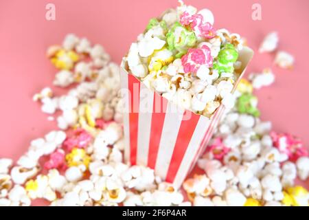 popcorn spilling from a container on red background  Stock Photo