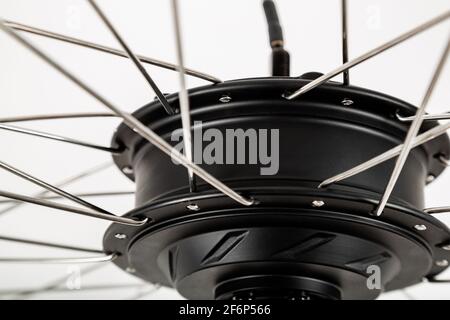 Electric motor close-up on a white background. Bicycle wheel. Stock Photo