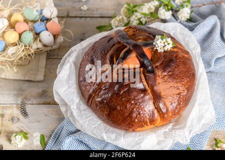 Portuguese traditional Easter cake. Folar with eggs on easter table. Colorful painted eggs. Stock Photo