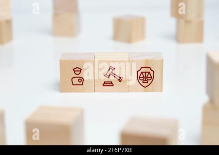 The concept of the interaction of the court with the law and police structures on wooden cubes. Stock Photo