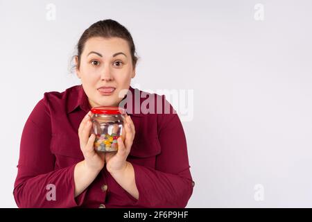 The concept of lifestyle and food. Delighted happy woman looking surprised, receiving her favorite sweets, such as eating sweets, ordering online, on Stock Photo
