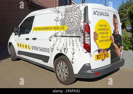 Close up side & back view graphic on installers white van advertising a home shower installation & improvement business parked on customers drive UK Stock Photo