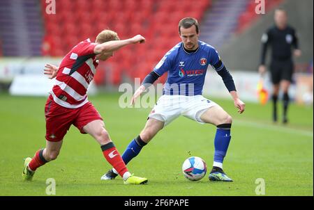 Charlton Athletic's Liam Millar (right) and Doncaster Rovers' Bradley Halliday (left) battle for the ball during the Sky Bet League One match at the Keepmoat Stadium, Doncaster. Picture date: Friday April 2, 2021. See PA story: SOCCER Doncaster. Photo credit should read: Nigel French/PA Wire. RESTRICTIONS: EDITORIAL USE ONLY No use with unauthorised audio, video, data, fixture lists, club/league logos or 'live' services. Online in-match use limited to 120 images, no video emulation. No use in betting, games or single club/league/player publications. Stock Photo