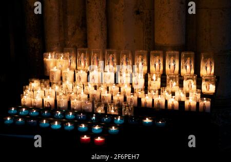 Christmas advent candle light in church with blurry golden bokeh for religious ritual, spiritual zen meditation, peaceful mind and soul or funeral wor Stock Photo