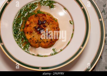 Kaspressknoedelsuppe, Beef Broth with Cheese Dumpling, a Traditional Soup from Western Austria Stock Photo