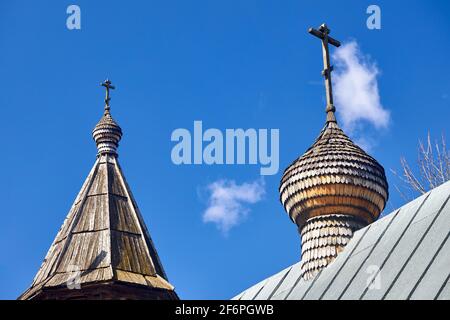 Two wooden dome with orthodox cross of Church of the Beheading of St. John the Baptist in European city Grodno or Hrodna Belarus on blue sky Stock Photo