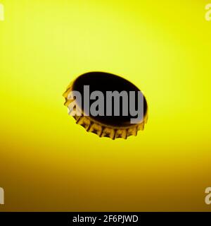 beer cap on yellow background Stock Photo