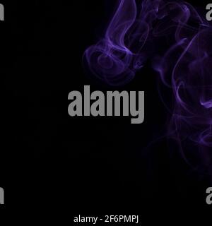 Beautiful swirls of purple smoke on a black background Stock Photo