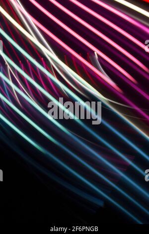 Pink and blue  light curve lines on a black background Stock Photo