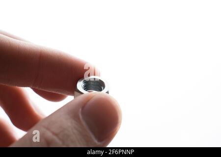 screw-nut in hands on a white background Stock Photo