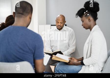 African Group Of People Reading Religious Book Together Stock Photo