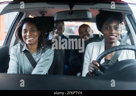 Carpool Ride Share Service App. Group Of African Friends Stock Photo