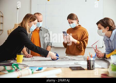 Clothes designer recording the cutting of fabric on video Stock Photo