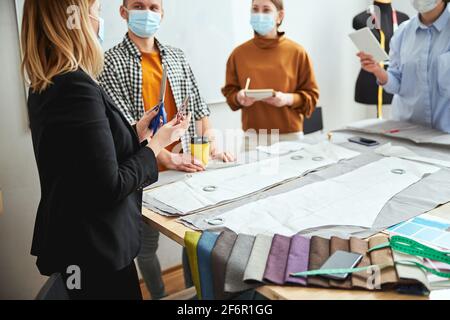 Fashion professional showing trainees two types of scissors Stock Photo