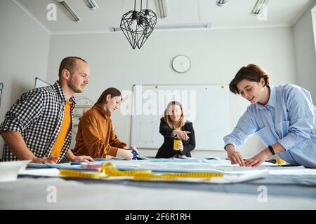 Beautiful woman doing markup along pattern with chalk Stock Photo