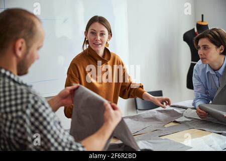 Surprised female looking at man with fabric sheet Stock Photo