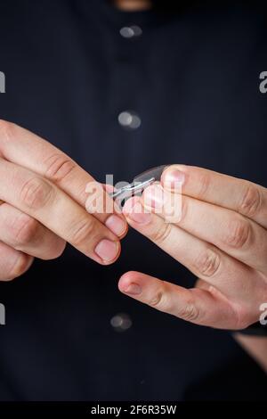 Doctor specialist holds a metal surgical scalpel in his hands Stock Photo